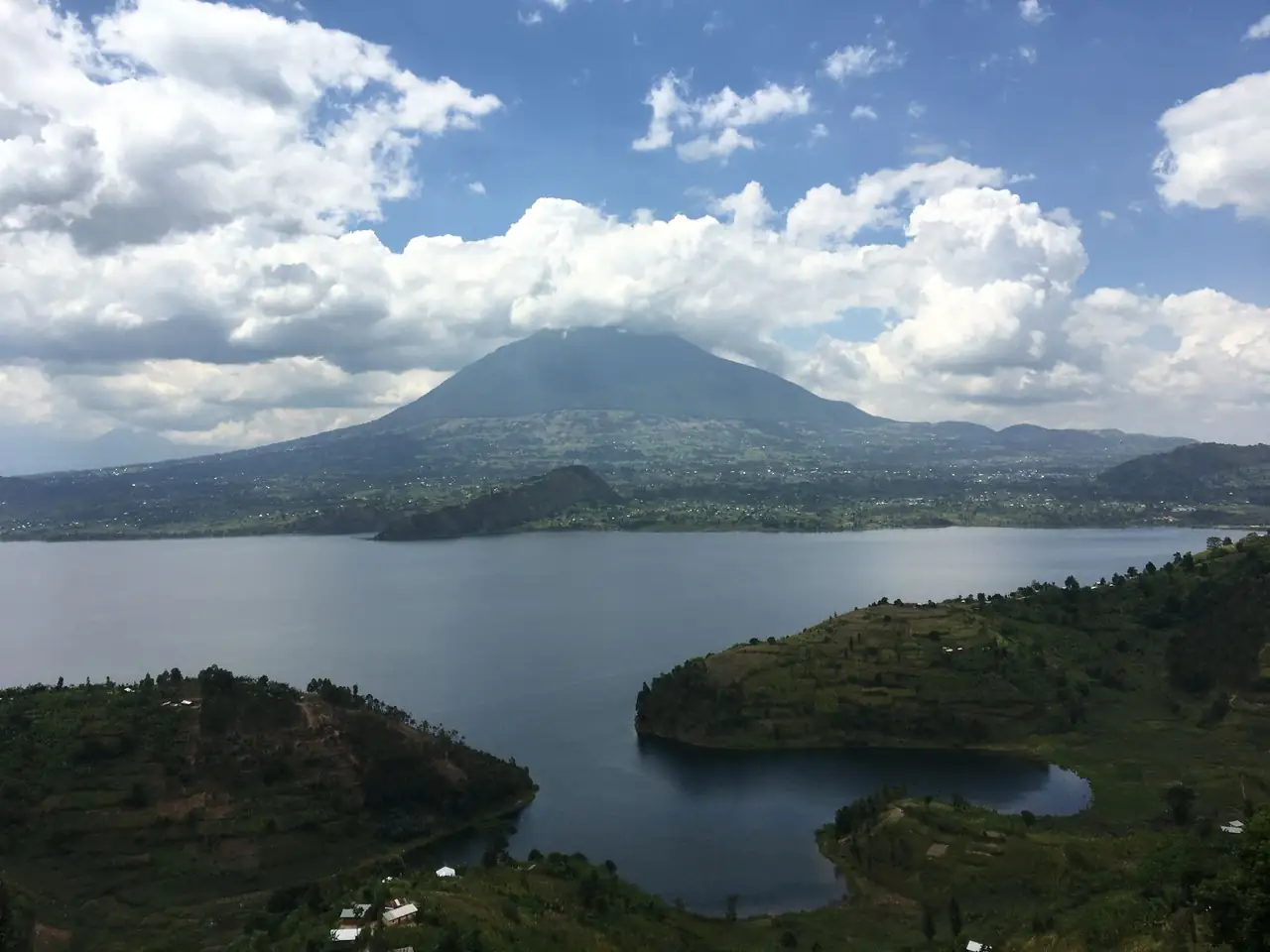 Beautiful landscape of a lake with mountains under a cloudy sky in Butaro, Rwanda.