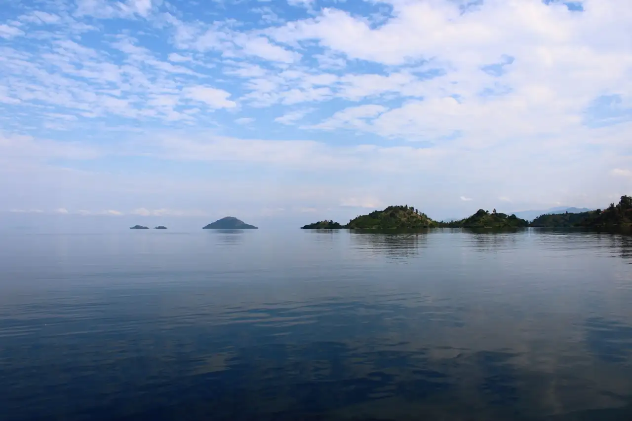 Discover the serene beauty of Lake Kivu's islands under a vast sky in Rwanda.